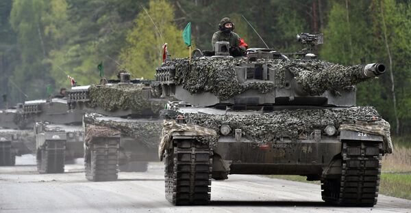 An Austrian soldier arrives with a tank type 'Leopard' prior the friendship shooting of several nations during the exercise 'Strong Europe Tank Challenge 2017' at the exercise area in Grafenwoehr, near Eschenbach, southern Germany, on May 12, 2017 - Sputnik International