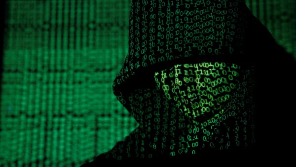 A projection of cyber code on a hooded man is pictured in this illustration picture taken on May 13, 2017 - Sputnik International