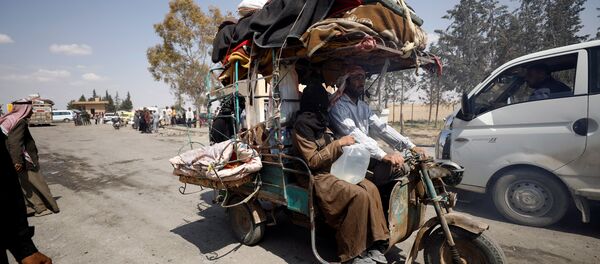 Internally displaced people who fled Raqqa city ride a tricycle with their belongings as they leave a camp in Ain Issa, Raqqa Governorate, Syria May 4, 2017 Internally displaced people who fled Raqqa city ride a tricycle with their belongings as they leave a camp in Ain Issa, Raqqa Governorate, Syria May 4, 2017 - Sputnik International