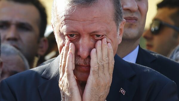 Turkish President Recep Tayyip Erdogan, right, wipes his tears - Sputnik International