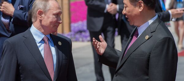 May 15, 2017. Russian President Vladimir Putin and Chinese President Xi Jinping, right, during a group photo session for the participants in a roundtable summit held as part of the Belt and Road Forum, in front of the Yanqi Lake International Convention Center. May 15, 2017. Russian President Vladimir Putin and Chinese President Xi Jinping, right, during a group photo session for the participants in a roundtable summit held as part of the Belt and Road Forum, in front of the Yanqi Lake International Convention Center. - Sputnik International