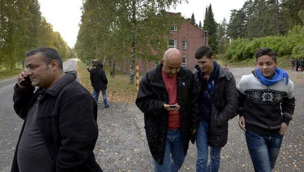 In this photo taken Friday, Sept. 25, 2015, Iraqi asylum seekers stand outside a refugee center located in the former army barracks, Lahti, Finland. Finland - Sputnik International