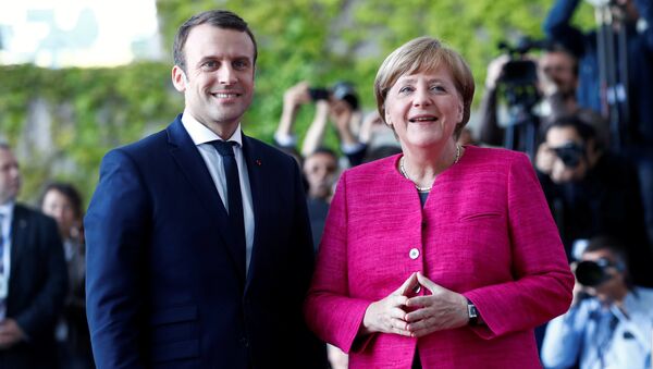 German Chancellor Angela Merkel and French President Emmanuel Macron arrive at a ceremony at the Chancellery in Berlin, Germany, May 15, 2017. - Sputnik International