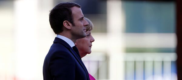 German Chancellor Angela Merkel and French President Emmanuel Macron listen to national anthems during a ceremony at the Chancellery in Berlin, Germany, May 15, 2017. - Sputnik International