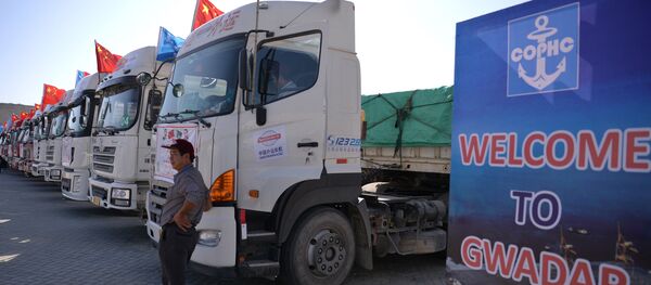 A Chinese worker stands near trucks carrying goods during the opening of a trade project in Gwadar port, some 700 kms west of the Pakistani city of Karachi on November 13, 2016. A Chinese worker stands near trucks carrying goods during the opening of a trade project in Gwadar port, some 700 kms west of the Pakistani city of Karachi on November 13, 2016. - Sputnik International