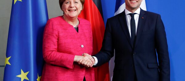 German Chancellor Angela Merkel and French President Emmanuel Macron shake hands after a news conference at the Chancellery in Berlin, Germany, May 15, 2017. - Sputnik International