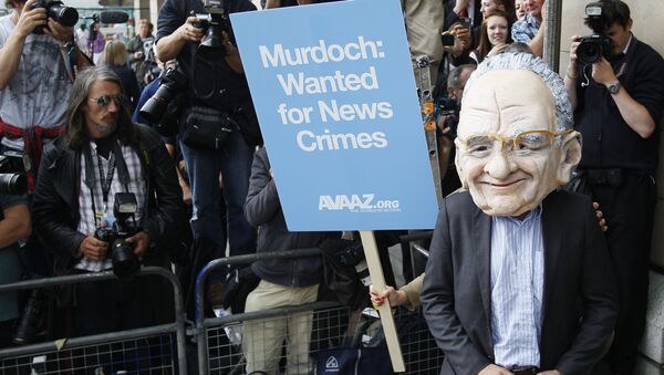 A protester wearing a Rupert Murdoch mask is photographed by media outside parliament in London, Tuesday, July 19, 2011. - Sputnik International
