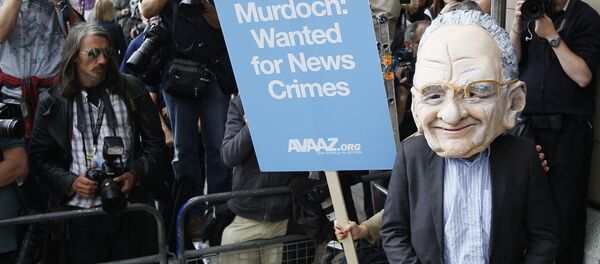 A protester wearing a Rupert Murdoch mask is photographed by media outside parliament in London, Tuesday, July 19, 2011. - Sputnik International