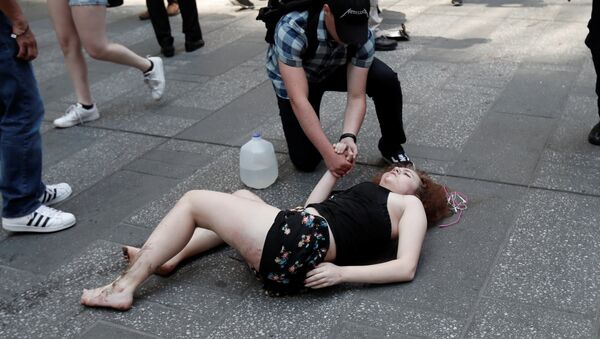 An injured woman lays on the sidewalk in Times Square after a speeding vehicle struck pedestirans on the sidewalk inn New York City, U.S., May 18, 2017 - Sputnik International