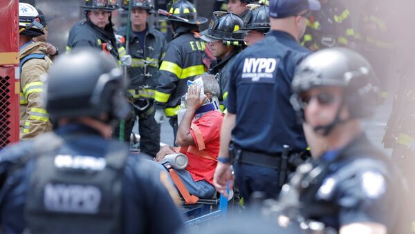 First responders tend to an injured pedestrian after a vehicle struck pedestrians on a sidewalk in Times Square in New York, U.S., May 18, 2017. - Sputnik International