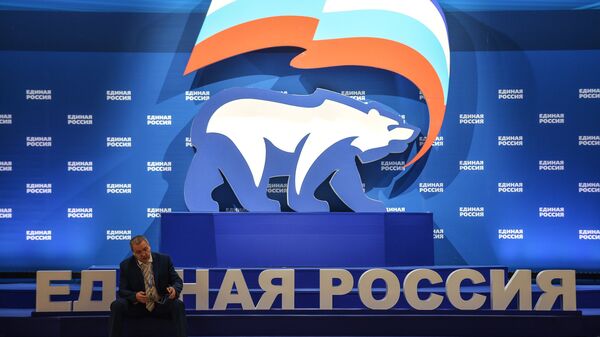 A man is seen here sitting next to a stand with United Russia symbols (File) - Sputnik International