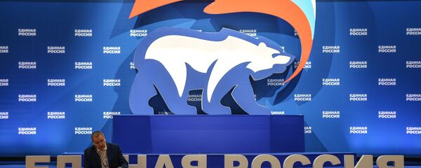 A man is seen here sitting next to a stand with United Russia symbols (File) A man is seen here sitting next to a stand with United Russia symbols (File) - Sputnik International