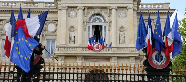 A worker arranges European flags alongside French national flags on the railings outside the Ministry of Foreign Affairs in Paris (File) A worker arranges European flags alongside French national flags on the railings outside the Ministry of Foreign Affairs in Paris (File) - Sputnik International