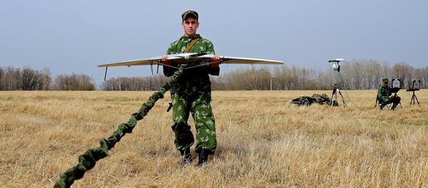 A serviceman of the reconnaissance unit of an Eastern Military District motorized rifle formation launches a drone during special tactical training at the Anastasyevsky base in the Khabarovsk Territory - Sputnik International