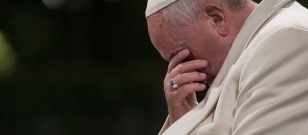 Pope Francis bows his heads and closes his eyes during the Via Crucis (Way of the Cross) torchlight procession in Rome, Friday, April 18, 2014 - Sputnik International