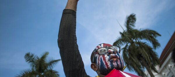 A Papuan rises his fist as he displays Morning Star separatist flags during a protest commemorating the 50th year since Indonesia took over West Papua from Dutch colonial rule in 1963, in Yogyakarta, Indonesia, May 1, 2013. - Sputnik International