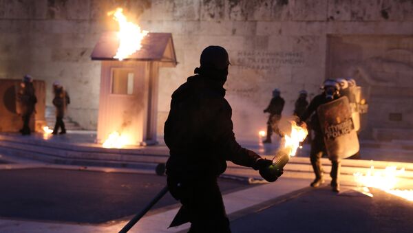 A masked demonstrator prepares to throw a petrol bomb to riot police outside the parliament building as Greek lawmakers vote on the latest round of austerity Greece has agreed with its lenders, in Athens, Greece, May 18, 2017. - Sputnik International