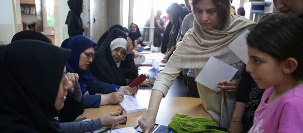 Voters cast their ballots during the presidential election in a Jewish and Christian district in the center of Tehran, Iran, May 19, 2017 Voters cast their ballots during the presidential election in a Jewish and Christian district in the center of Tehran, Iran, May 19, 2017 - Sputnik International