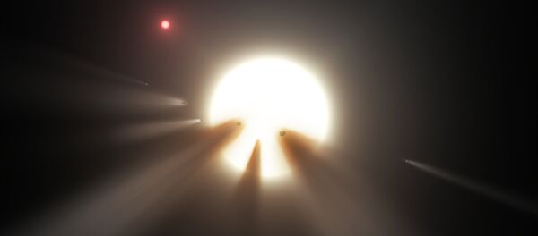 This illustration shows a star behind a shattered comet. Observations of the star KIC 8462852 by NASA's Kepler and Spitzer space telescopes suggest that its unusual light signals are likely from dusty comet fragments, which blocked the light of the star as they passed in front of it in 2011 and 2013 This illustration shows a star behind a shattered comet. Observations of the star KIC 8462852 by NASA's Kepler and Spitzer space telescopes suggest that its unusual light signals are likely from dusty comet fragments, which blocked the light of the star as they passed in front of it in 2011 and 2013 - Sputnik International