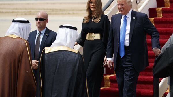 U.S. President Donald Trump, accompanied by first lady Melania Trump, smiles at Saudi King Salman, left, upon his arrival at a welcome ceremony at the Royal Terminal of King Khalid International Airport, Saturday, May 20, 2017, in Riyadh. - Sputnik International