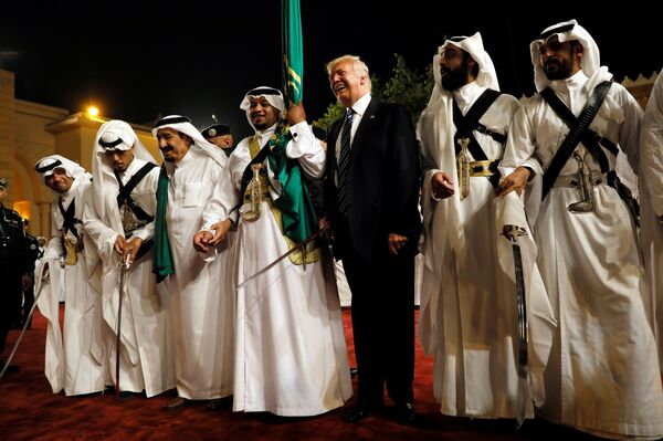 U.S. President Donald Trump dances with a sword as he arrives to a welcome ceremony at Al Murabba Palace in Riyadh, Saudi Arabia May 20, 2017 - Sputnik International