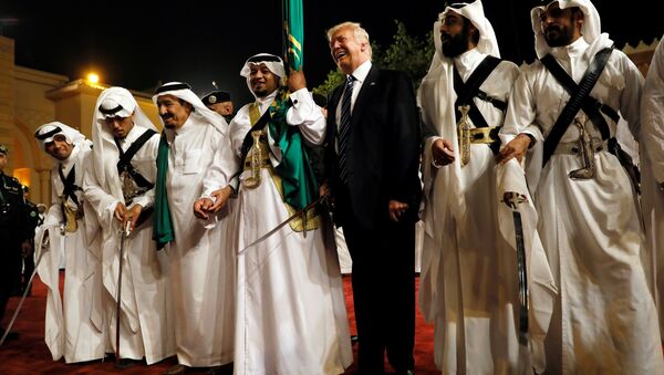 U.S. President Donald Trump dances with a sword as he arrives to a welcome ceremony at Al Murabba Palace in Riyadh, Saudi Arabia May 20, 2017 - Sputnik International