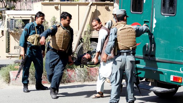 Afghan policemen transport a dead body of a police after gunmen attack in Jalalabad city eastern Afghanistan May 17, 2017 - Sputnik International