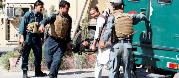 Afghan policemen transport a dead body of a police after gunmen attack in Jalalabad city eastern Afghanistan May 17, 2017 - Sputnik International