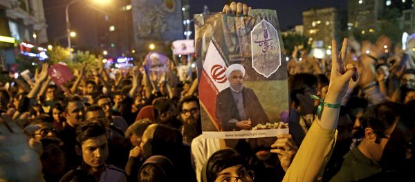 Supporters of Iranian President Hassan Rouhani celebrate after he won the presidential election in Tehran, Iran, Saturday, May 20, 2017 Supporters of Iranian President Hassan Rouhani celebrate after he won the presidential election in Tehran, Iran, Saturday, May 20, 2017 - Sputnik International
