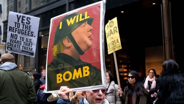 Anti-war protesters shout slogans against US President Donald Trump during a demonstration in front of the Trump Tower in New York on April 7, 2017, to protest the US air strike in Syria - Sputnik International