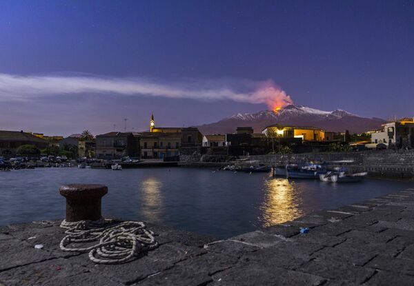 Snow-covered Mount Etna, Europe's most active volcano, spews lava during an eruption as the Sicilian village of Pozzillo, Italy, is visible in foreground, in the early hours of Tuesday, April 11, 2017 Snow-covered Mount Etna, Europe's most active volcano, spews lava during an eruption as the Sicilian village of Pozzillo, Italy, is visible in foreground, in the early hours of Tuesday, April 11, 2017 - Sputnik International