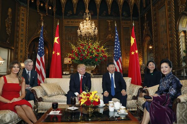 President Donald Trump and Chinese President Xi Jinping, sit with their wives, first lady Melania Trump, left, and Chinese first lady Peng Liyuan, right, before a meeting at Mar-a-Lago, Thursday, April 6, 2017, in Palm Beach, Fla - Sputnik International