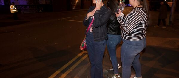 Concert goers react after fleeing the Manchester Arena in northern England where U.S. singer Ariana Grande had been performing in Manchester Concert goers react after fleeing the Manchester Arena in northern England where U.S. singer Ariana Grande had been performing in Manchester - Sputnik International