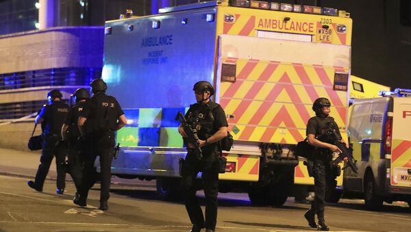 Police stand near an ambulance at Manchester Arena after reports of an explosion at the venue during an Ariana Grande concert on Monday, May 22, 2017. - Sputnik International