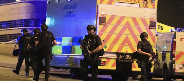 Police stand near an ambulance at Manchester Arena after reports of an explosion at the venue during an Ariana Grande concert on Monday, May 22, 2017. - Sputnik International