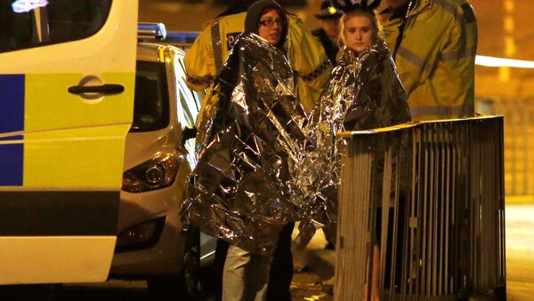 Two women wrapped in thermal blankets stand near the Manchester Arena, where U.S. singer Ariana Grande had been performing, in Manchester, northern England, Britain, May 23, 2017. - Sputnik International