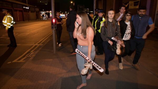 Concert goers react after fleeing the Manchester Arena in northern England where U.S. singer Ariana Grande had been performing in Manchester, Britain, May 22, 2017. - Sputnik International
