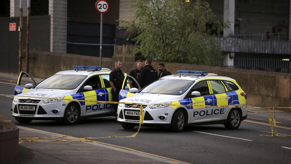 Police officers stand next to their vehicles near the Manchester Arena after a blast at Ariana Grande concert Tuesday May 23, 2017 - Sputnik International