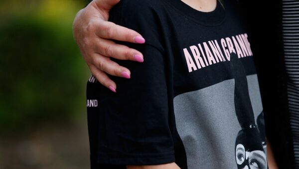 A youngster wearing a t-shirt showing U.S. singer Ariana Grande talks to the media near the Manchester Arena in Manchester, Britain May 23, 2017. - Sputnik International