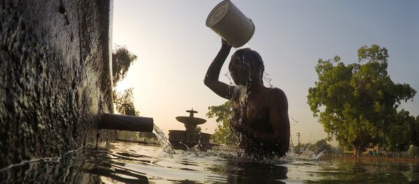 An Indian man bathes in a decorative pool in the gardens surrounding the India Gate monument in New Delhi on May 2, 2017. - Sputnik International