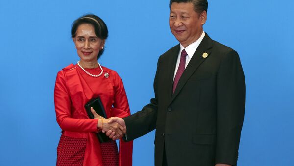 Chinese President Xi Jinping, right, shakes hands with Myanmar's State Counselor Aung San Suu Kyi as they attend the welcome ceremony at Yanqi Lake during the Belt and Road Forum, in Beijing, Monday, May 15, 2017. - Sputnik International