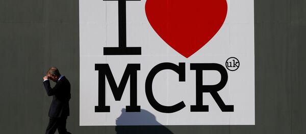 A man walks past a sign in central Manchester, Britain May 25, 2017. - Sputnik International