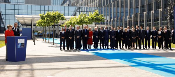 German Chancellor Angela Merkel (L) speaks beside NATO Secretary General Jens Stoltenberg and NATO members leaders at the start of the NATO summit at their new headquarters in Brussels, Belgium German Chancellor Angela Merkel (L) speaks beside NATO Secretary General Jens Stoltenberg and NATO members leaders at the start of the NATO summit at their new headquarters in Brussels, Belgium - Sputnik International