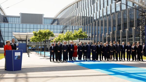 German Chancellor Angela Merkel (L) speaks beside NATO Secretary General Jens Stoltenberg and NATO members leaders at the start of the NATO summit at their new headquarters in Brussels, Belgium - Sputnik International