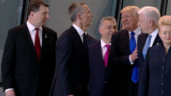 In this image taken from NATO TV, Montenegro Prime Minister Dusko Markovic, second right, appears to be pushed by US President Donald Trump - Sputnik International