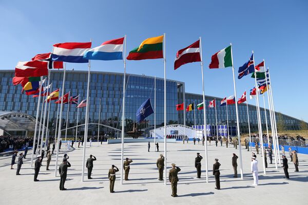 Flags of NATO member countires fly during a ceremony at the new NATO headquarters before the start of a summit in Brussels, Belgium, May 25, 2017 - Sputnik International