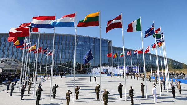 Flags of NATO member countires fly during a ceremony at the new NATO headquarters before the start of a summit in Brussels, Belgium, May 25, 2017 - Sputnik International