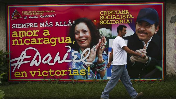 A man walks past a billboard promoting Nicaragua's President Daniel Ortega and running mate, his wife Rosario Murillo, in Managua, Nicaragua, Saturday, Nov. 5, 2016 - Sputnik International
