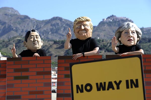Protesters wear masks depicting the leaders of the G7 countries during a demonstration organised by Oxfam in Giardini Naxos near Taormina, Sicily, Italy, May 27, 2017 Protesters wear masks depicting the leaders of the G7 countries during a demonstration organised by Oxfam in Giardini Naxos near Taormina, Sicily, Italy, May 27, 2017 - Sputnik International