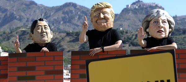 Protesters wear masks depicting the leaders of the G7 countries during a demonstration organised by Oxfam in Giardini Naxos near Taormina, Sicily, Italy, May 27, 2017 - Sputnik International
